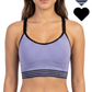 Woman wearing a purple sports bra with black straps on a white background