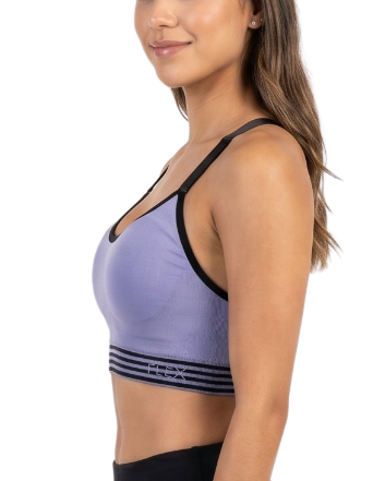 Woman wearing a purple sports bra and black leggings on a white background