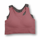 Pink and gray sports bra on a white background