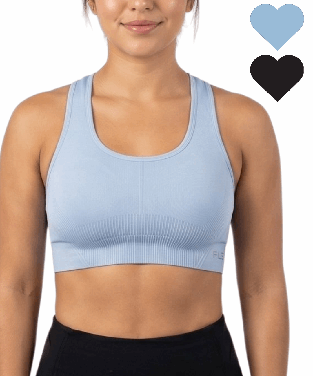 Woman wearing a light blue sports bra with black hearts on a white background