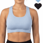 Woman wearing a light blue sports bra with black hearts on a white background