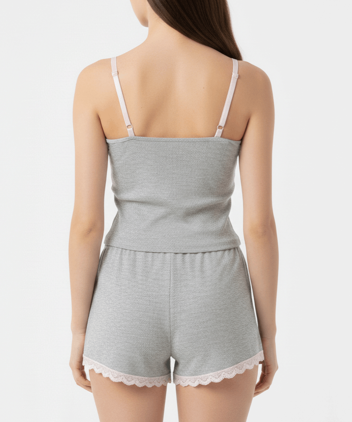 Light gray romper with lace trim on a plain background