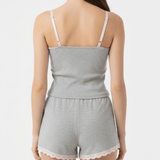 Light gray romper with lace trim on a plain background