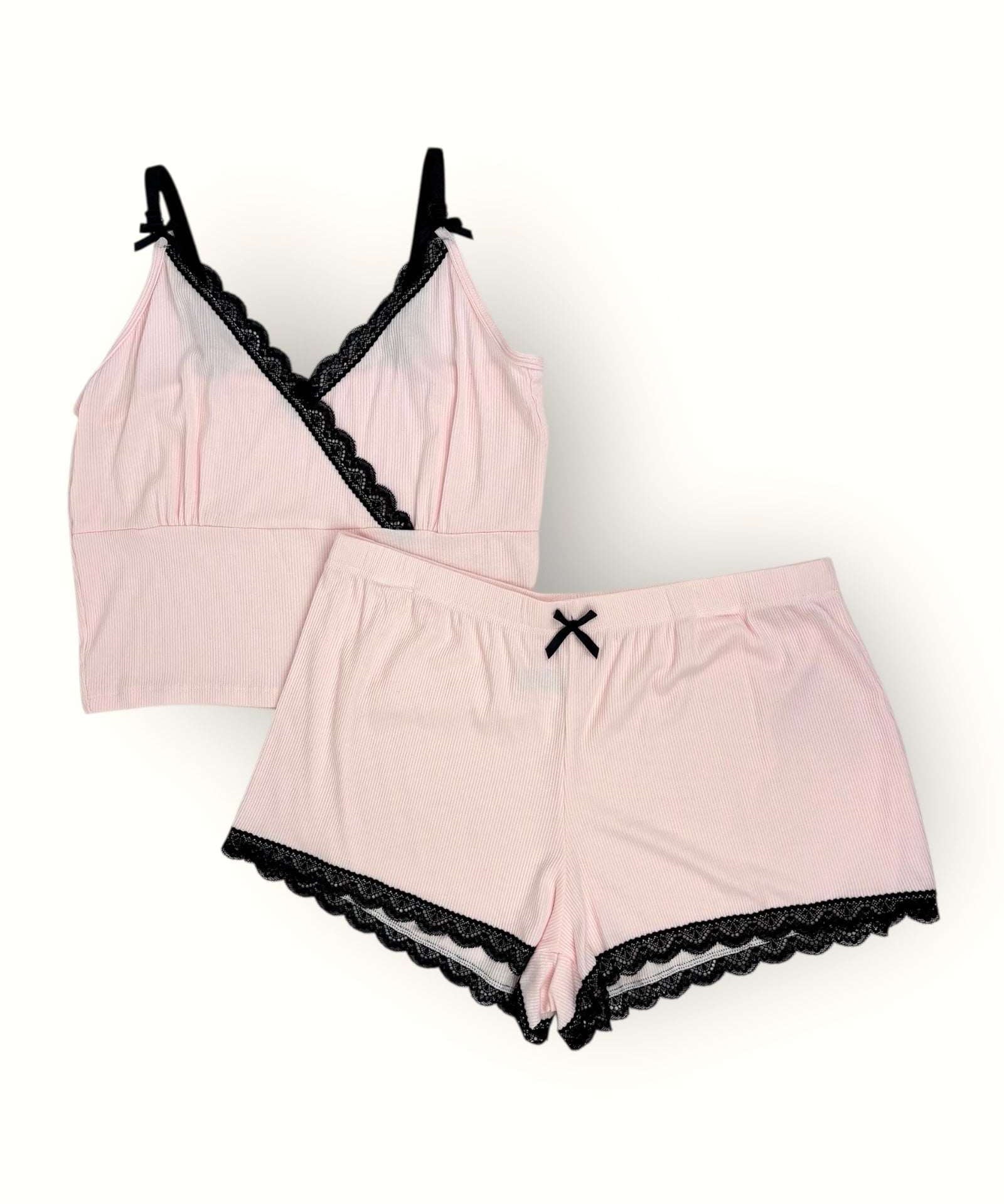 Pink lingerie set with black lace trim on a white background