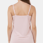 Light pink slip dress worn by a model on a white background