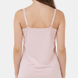 Light pink slip dress worn by a model on a white background
