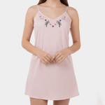 Pink nightgown with floral embroidery on a white background
