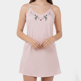 Pink nightgown with floral embroidery on a white background