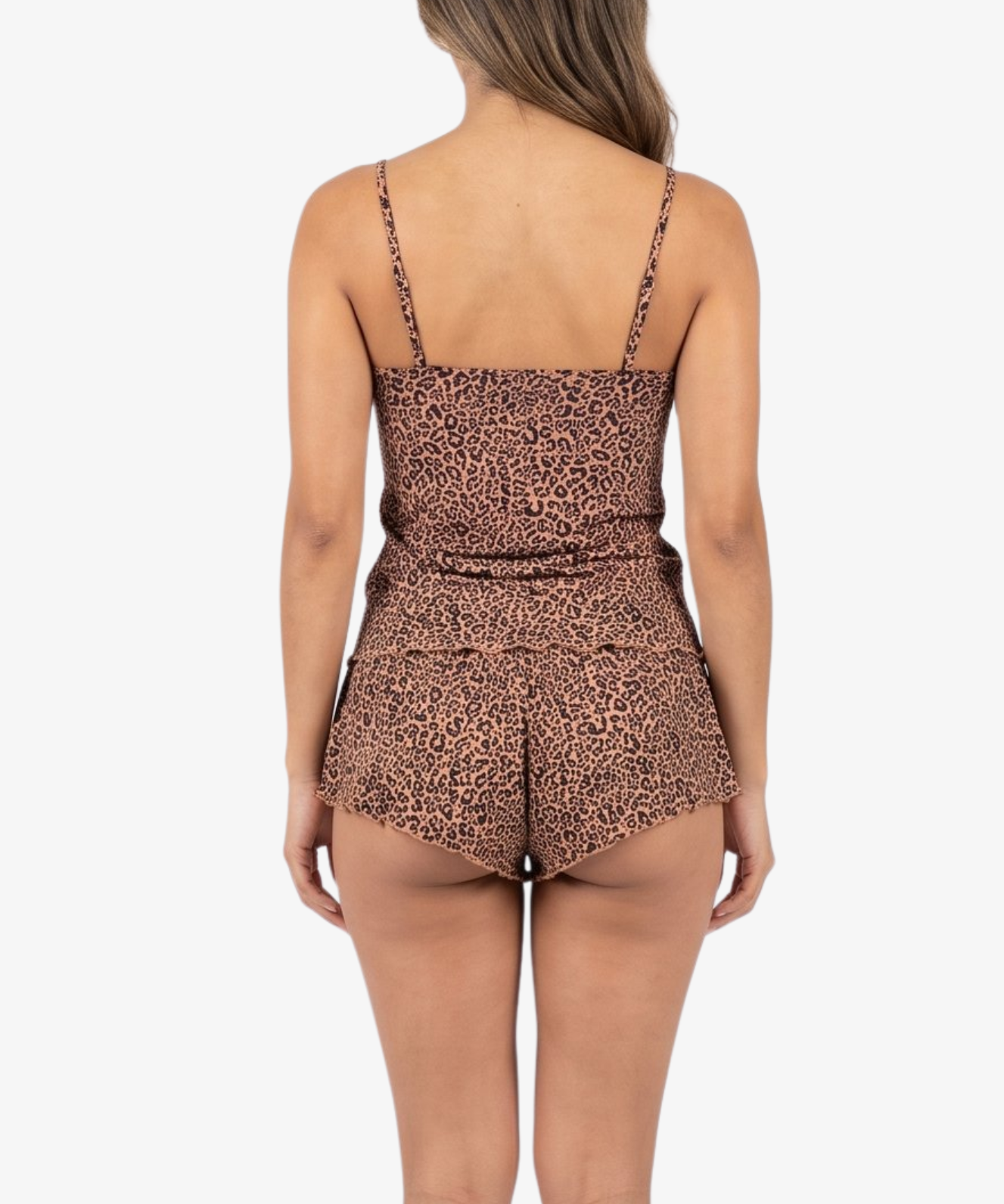 A woman viewed from the back wearing a sleeveless leopard-print pajama set with thin straps and a gathered waist, against a plain light gray studio background.