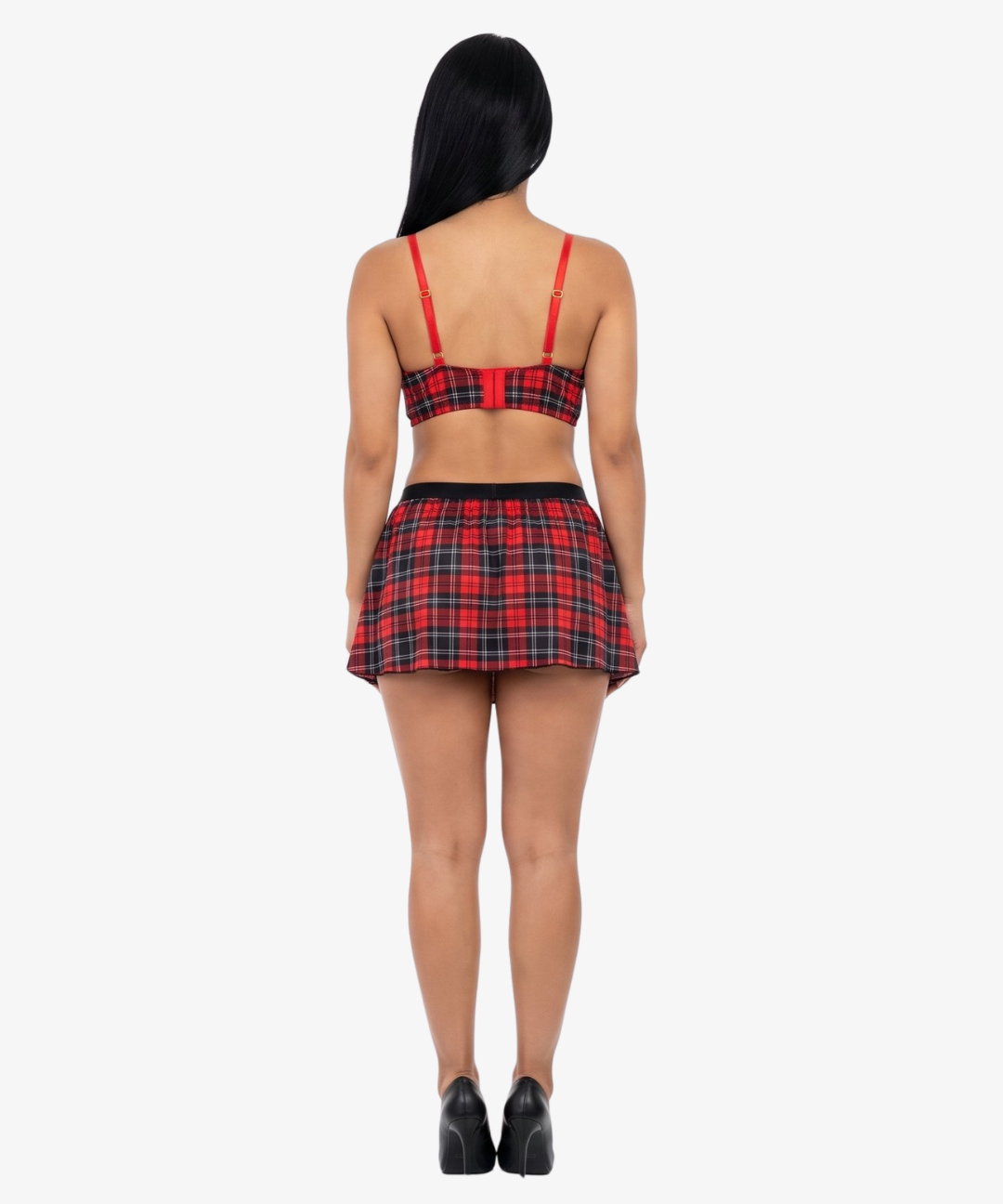 Woman wearing a red and black plaid top and skirt on a white background