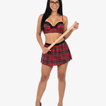 Woman wearing a red plaid outfit holding a wooden stick on a white background
