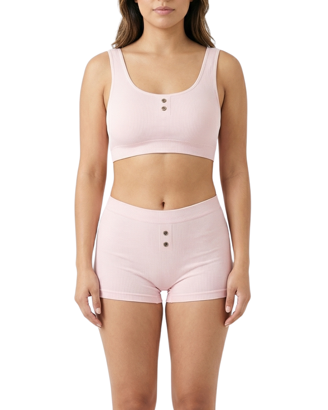 Woman wearing a pink comfort bra and shorts set on a white background