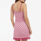 Pink nightgown with heart pattern worn by a model on a white background