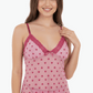 Pink nightgown with heart pattern worn by a model on a white background