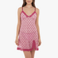Pink nightgown with heart pattern worn by a model on a white background