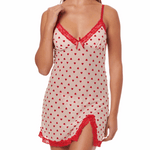 Woman wearing a red and white heart-patterned nightgown with lace trim on a white background