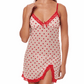 Woman wearing a red and white heart-patterned nightgown with lace trim on a white background