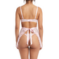 Woman wearing a pink lingerie set with a white background