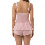 Woman wearing a pink peplum top and shorts set on a white background