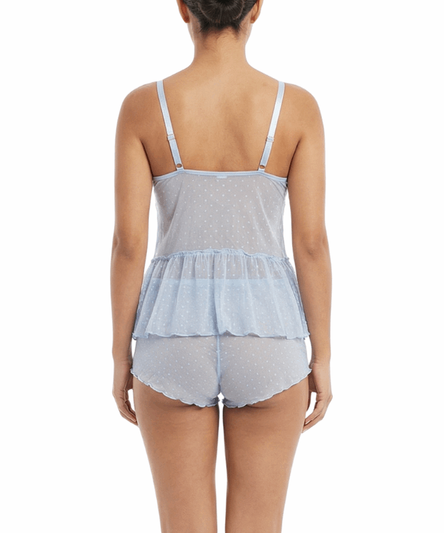 Woman wearing a light blue peplum top and matching shorts on a white background