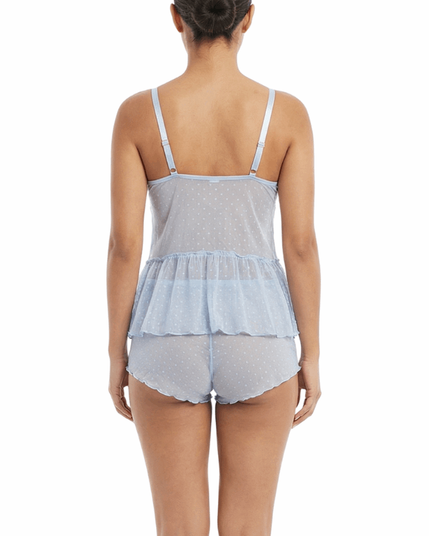 Woman wearing a light blue peplum top and matching shorts on a white background