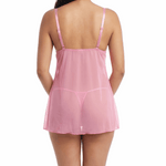 Woman wearing a pink lace babydoll lingerie on a white background