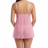 Woman wearing a pink lace babydoll lingerie on a white background