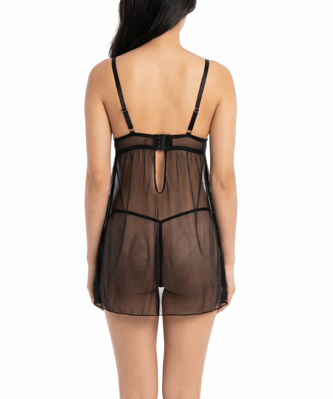 Woman wearing a sheer black nightgown on a white background