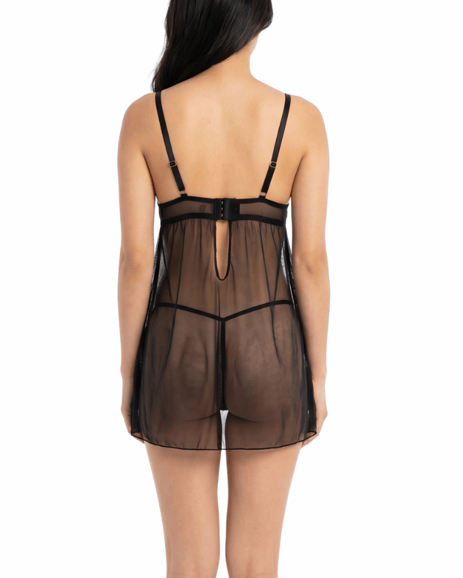 Woman wearing a sheer black nightgown on a white background
