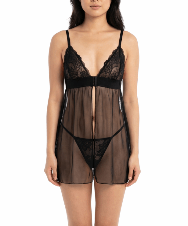 Woman wearing a black lace lingerie set on a white background