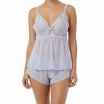Woman wearing a light blue cami pajama set on a white background