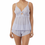 Woman wearing a light blue cami pajama set on a white background