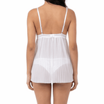 Woman wearing a white lace nightgown on a white background