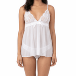 Woman wearing a white lace nightgown on a white background