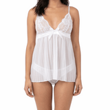 Woman wearing a white lace nightgown on a white background