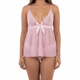 Woman wearing a pink lace nightgown on a white background
