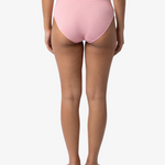 A woman modeling a light pink bikinis panty set against a plain light gray background.