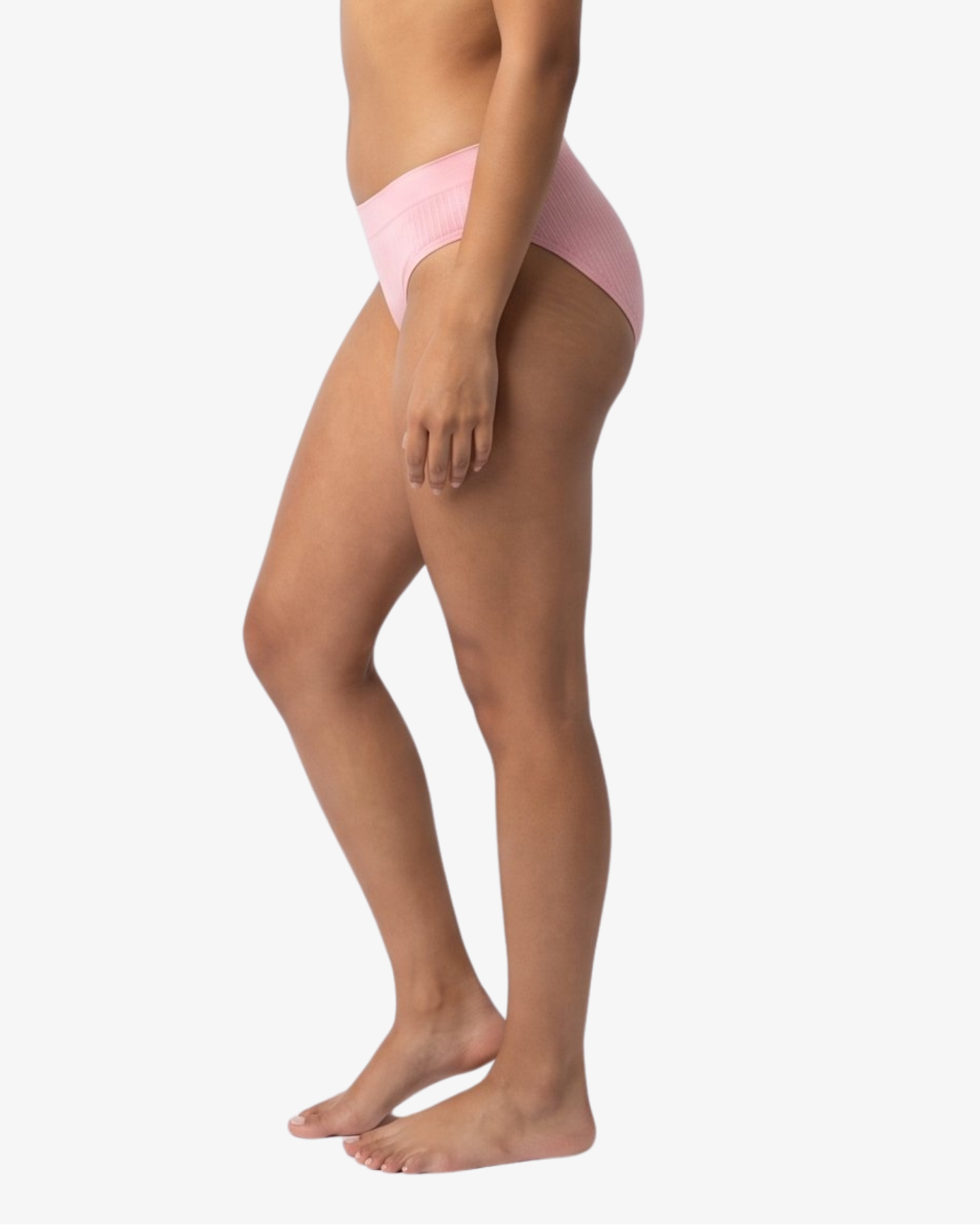 A woman modeling a light pink bikinis panty set against a plain light gray background.