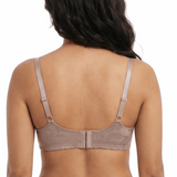 Woman wearing a beige bra on a white background