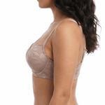 Woman wearing a beige bra on a white background