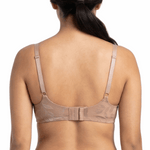 Woman wearing beige lingerie set on a white background