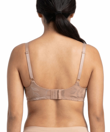 Woman wearing beige lingerie set on a white background