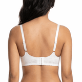 Woman wearing a white bra on a white background