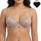 Woman wearing a beige bra with floral lace details on a white background