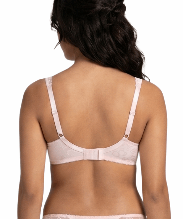 Woman wearing a light pink lingerie bra on a white background