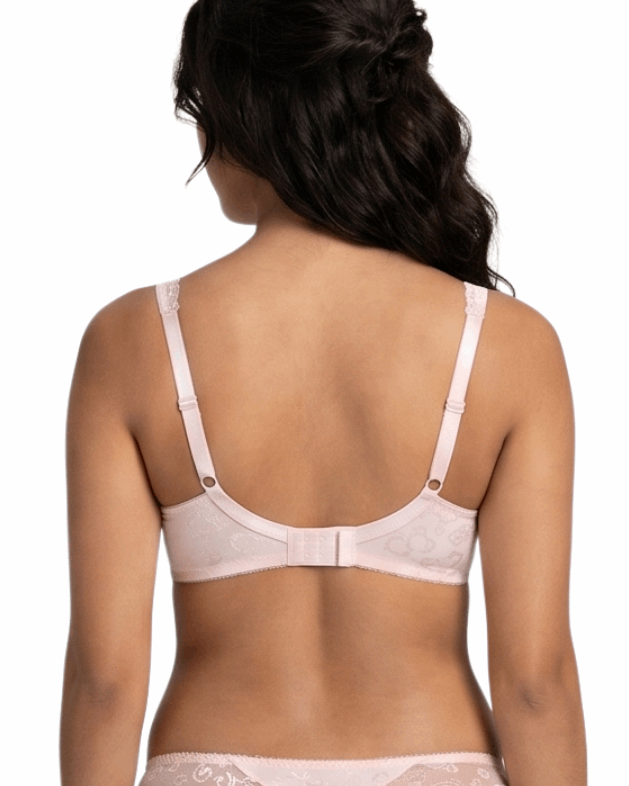 Woman wearing a light pink lingerie bra on a white background