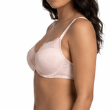 Woman wearing a light pink bra and panties set on a white background