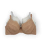 Nude bra with lace details on a white background