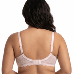Woman wearing light pink comfort bra in a white background.
