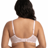 Woman wearing light pink comfort bra in a white background.